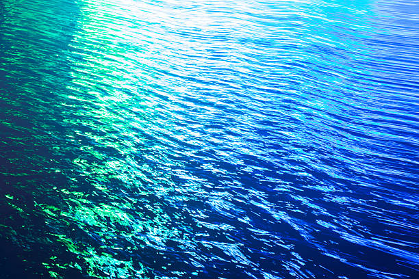 Diffused daylight making gentle reflections on the rippled waves of a water surface.