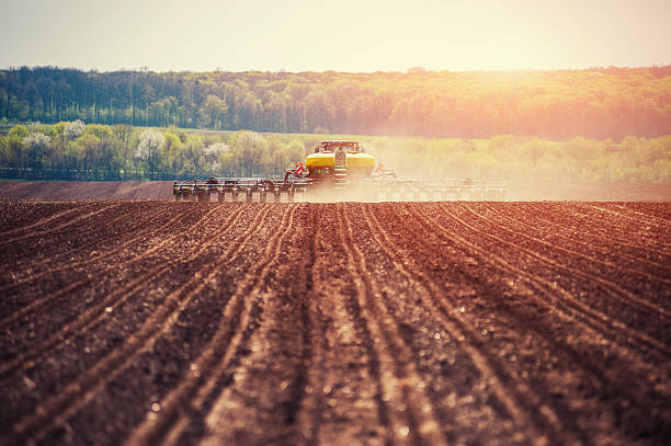 tracteur labourant le champ agricole en préparation pour la plantation de printemps. - chemical plant photos et images de collection