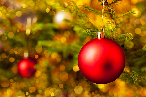 istock Decoration bauble on decorated Christmas tree background 607595758