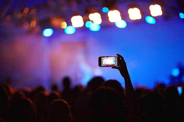 istock Fan Filming Concert with Smartphone 607596418