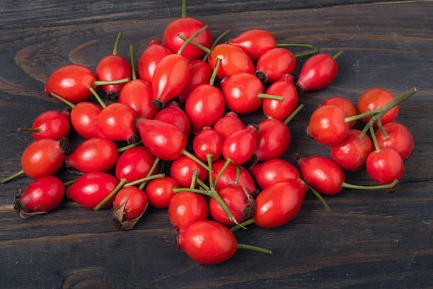 istock fresh rose hips on a dark wooden background 607596996