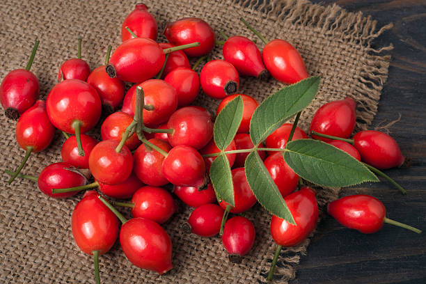 istock fresh rose hips on a wooden table with sacking 607597122