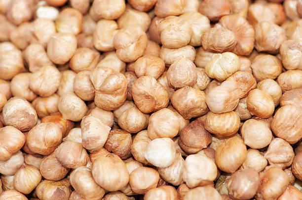 istock Heap of peeled hazelnuts, hazelnut as background 607597552