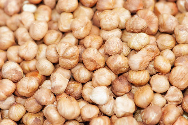Heap of peeled hazelnuts, hazelnut as background stock photo