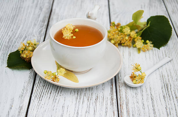 istock cup of herbal tea with linden flowers 607601112