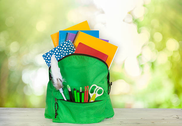 istock Backpack on wooden table in garden 607603612