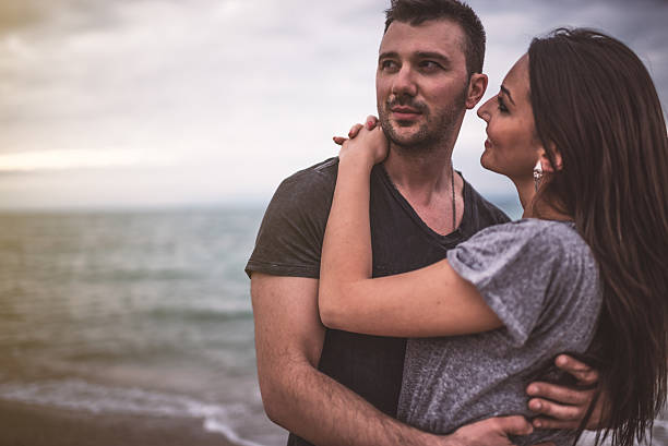 istock Young couple at the beach 607604228