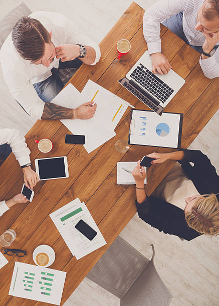 istock Group of busy business people working in office, top view 607604968