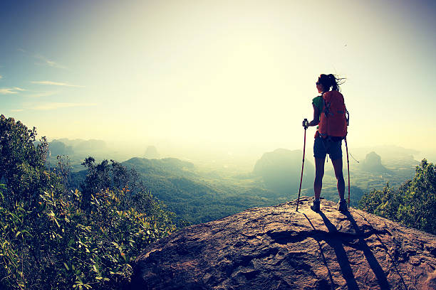 istock successful woman hiker at sunrise mountain peak 607605020