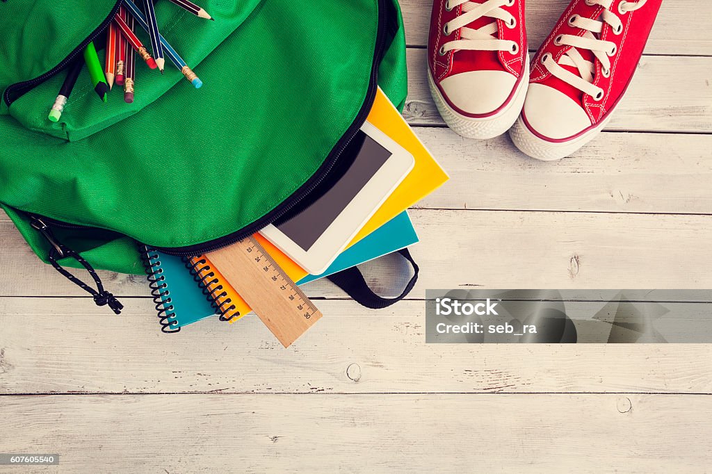 School backpack on wooden background Back to School Stock Photo