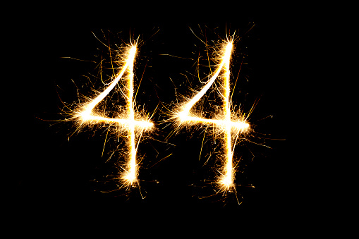Number 44 made with sparklers  on black background