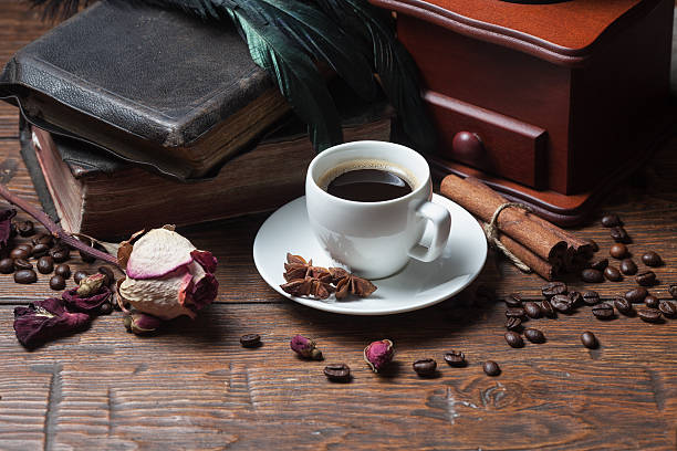 istock Cup of coffee, dry rose and grinder 607608838
