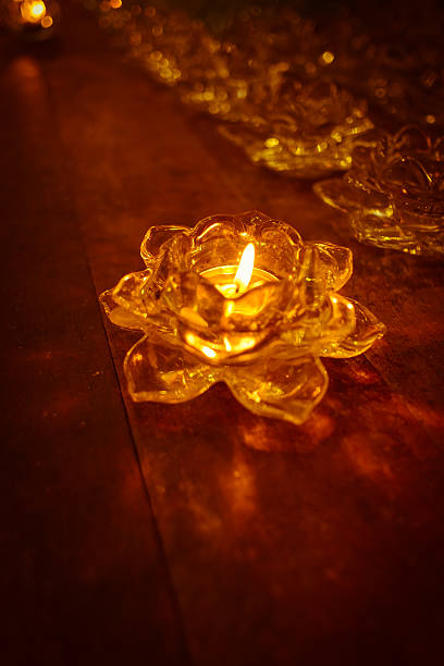 istock Candlelight in tray rosette on old wooden. 607608978