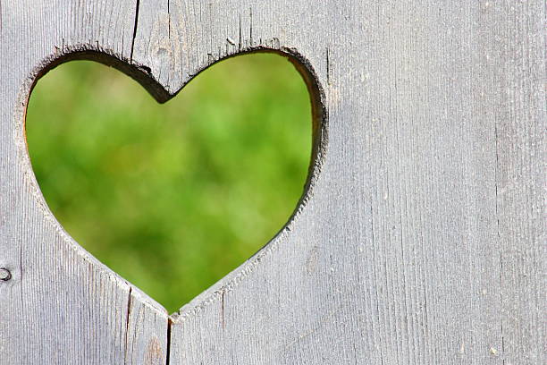 istock Wooden background with green heart 607609022