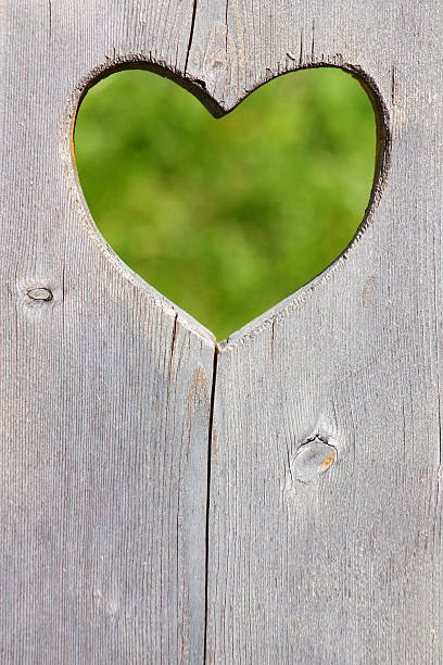istock Wooden background with green heart 607609026