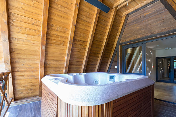 istock Hot tub with wooden frame on mountain hotel terace 607609458
