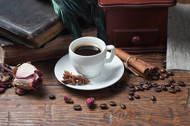 istock Cup of coffee, dry rose and grinder 607609568