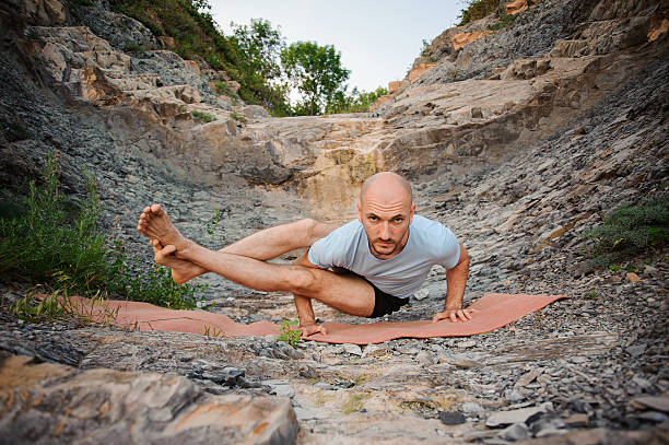 istock Young man doing an ashtavakrasana. Hand standing 607612064