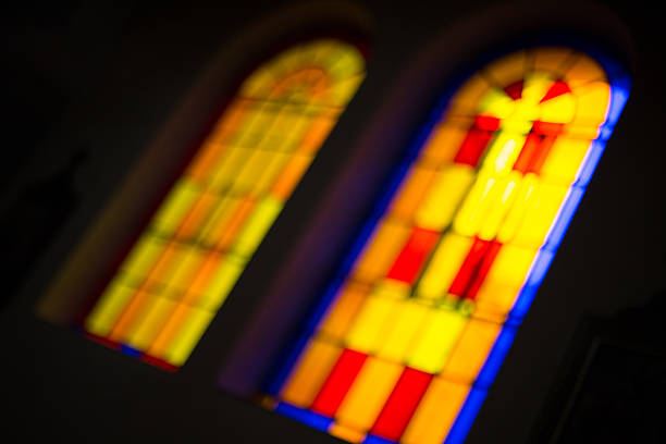 istock Stained glass in monastery, black background 607613170
