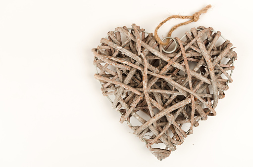 Wooden aged heart on white background. Christmas ornament. Studio shot with high professional equipment.