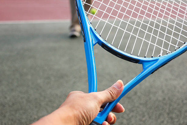 istock Female athlete holding tennis racket 607614222
