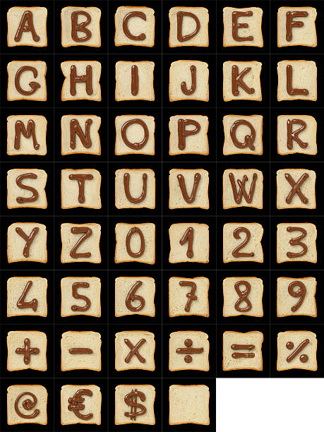 Alphanumeric symbols drawn with Nutella on bread slices on black