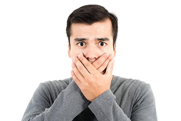 istock Shocked man with hands covering mouth 607615264