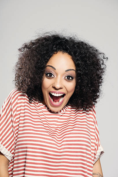 istock Surprised afro american woman laughing 607617060