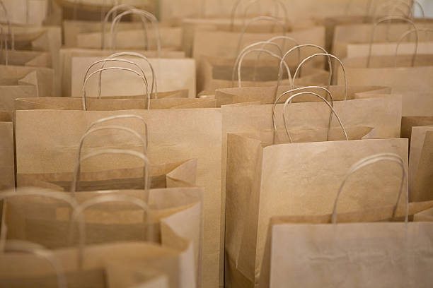 istock Brown paper bags in rows 607619114