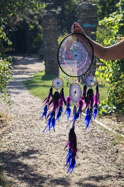 istock Dreamcatcher made of feathers, leather, beads, and ropes 607620920