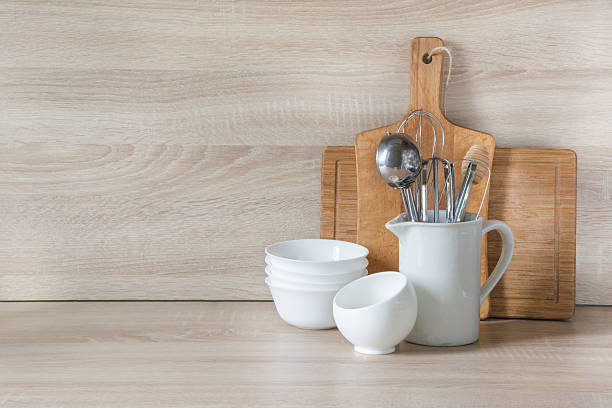 Crockery, utensils and other different stuff on wooden table.  Copyspace.