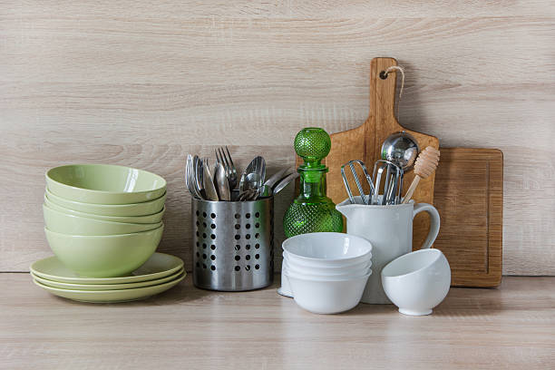 istock Crockery, utensils and other different stuff on wooden table.  Copyspace. 607621682