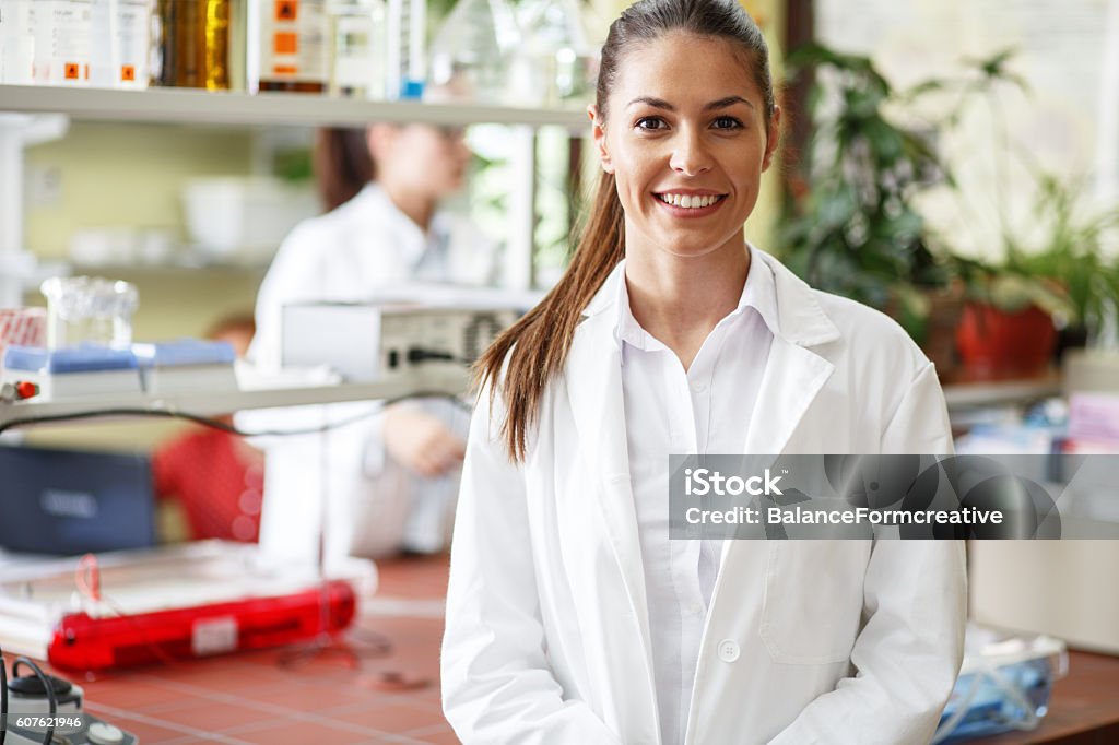 Young female scientist. Young female scientist standing in her lab. Scientist Stock Photo