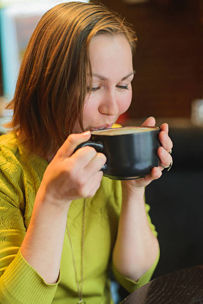 istock adult girl drinks coffee 607638688
