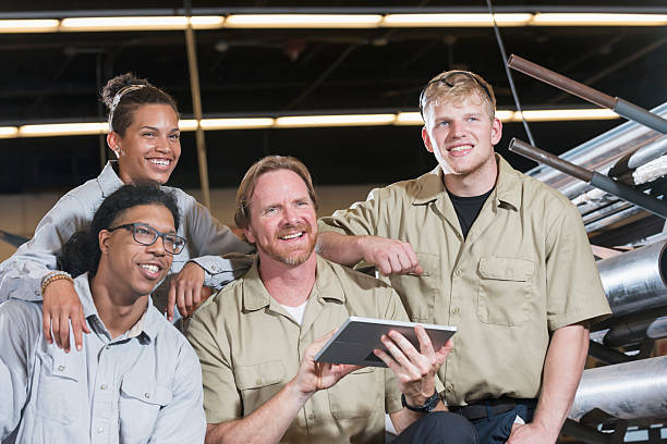 istock Multi-ethnic group of factory workers with supervisor 607648782