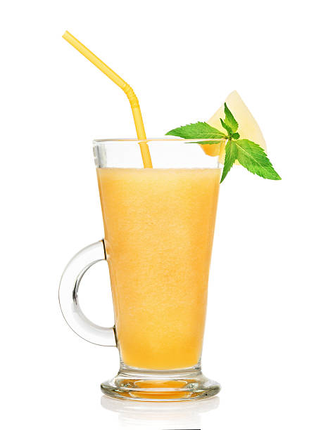 fresh melon smoothie in a glass isolated stock photo