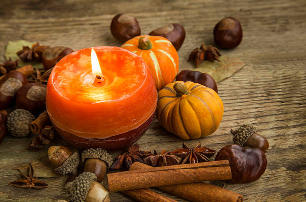 istock Autumn candle decoration with cinnamon sticks, acorns,anise and 607652774