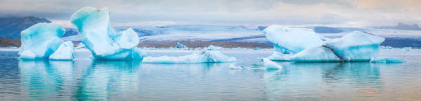 istock Icebergs floating in Arctic ocean lagoon below glaciers panorama Iceland 607655490