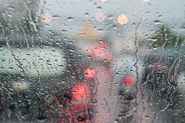 istock Water drop on windshield of car in rainy season. 607729300