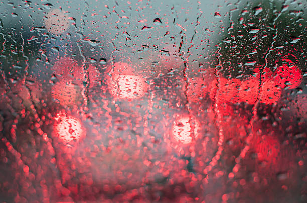 istock Water drop on windshield of car in rainy season. 607729458