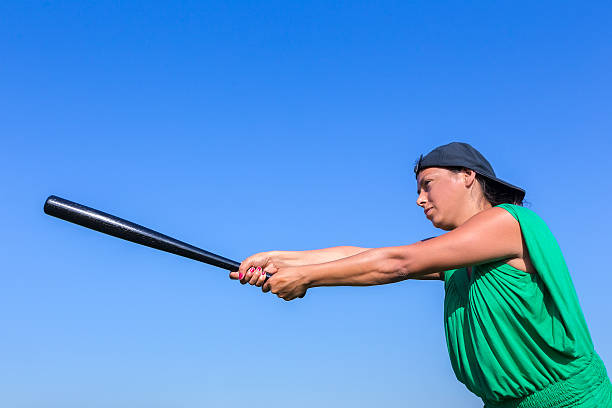 istock Woman with baseball bat body posture to strike 607729614