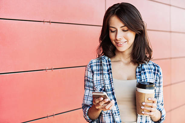 istock Coffee break, young woman using smart phone 607729912