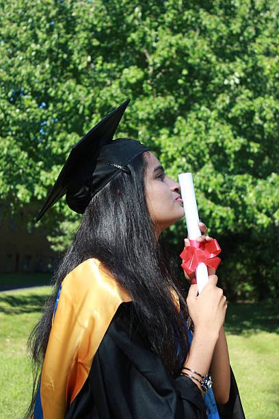 istock indian graduate kissing degree 607730352