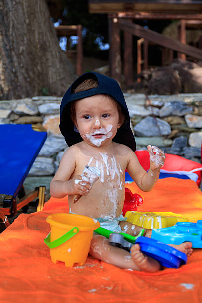 Happy baby smeared with ice stock photo