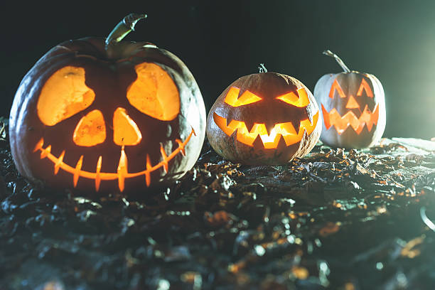 istock Halloween pumpkins at wood background. 607731872