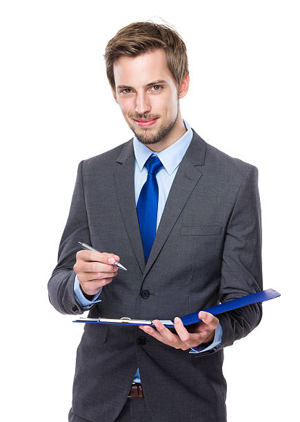 istock Businessman writing on a clipboard 607734110