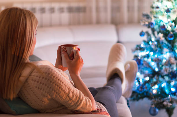 istock Woman at home drinking tea. It's Christmas 607734702