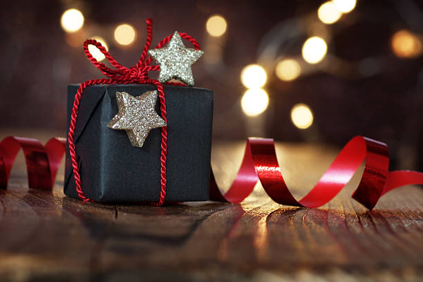 Gift for christmas eve Gift for Christmas Eve with stars and bokeh stars in your eyes stock pictures, royalty-free photos & images