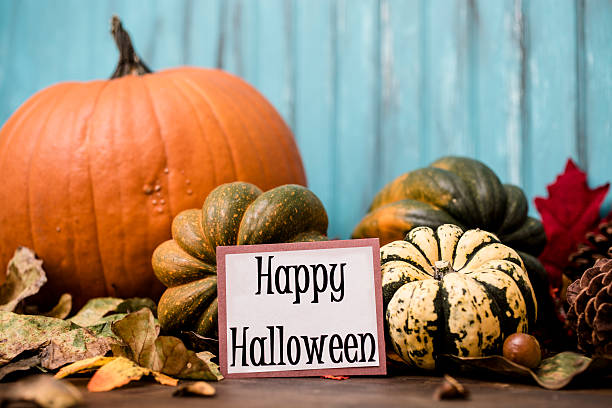istock Happy Halloween!  Autumn centerpiece with orange pumpkin, leaf decorations. 607736716