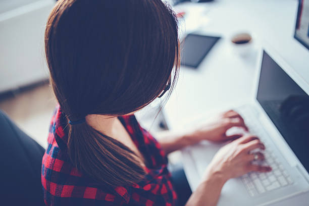 istock Girl typing on laptop 607738442
